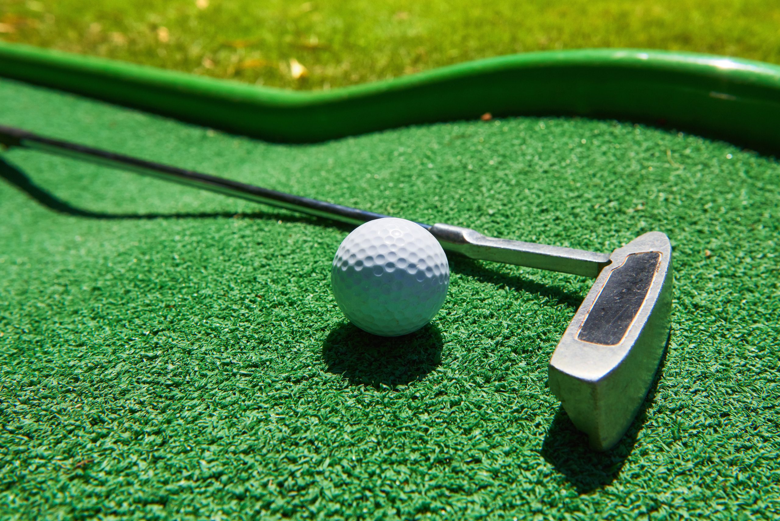 Golf ball and Golf Club on Artificial Grass golf-ball-golf-club-artificial-grass
